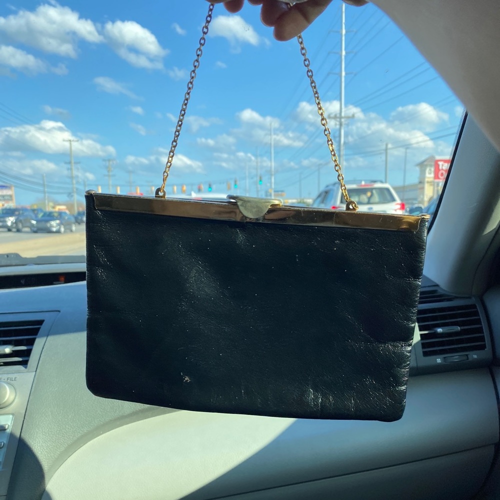 Gold inside black leather outside and folds sides when you open